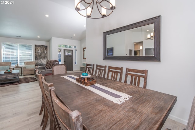 dining space featuring a chandelier, recessed lighting, baseboards, and light wood finished floors