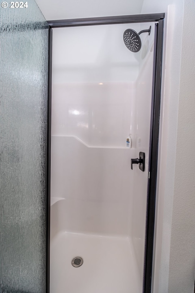 bathroom featuring a shower stall