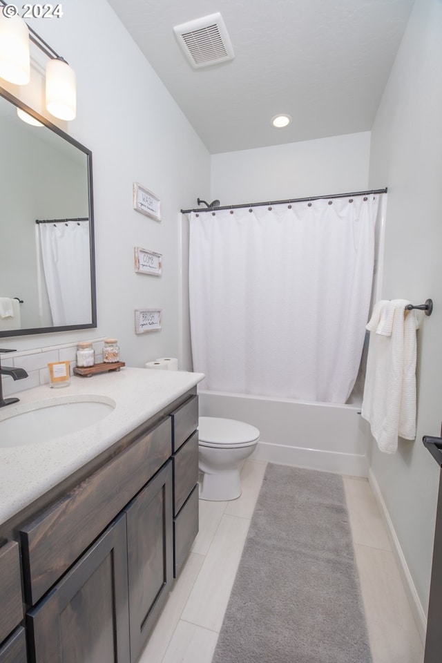 bathroom with toilet, vanity, tile patterned flooring, and visible vents