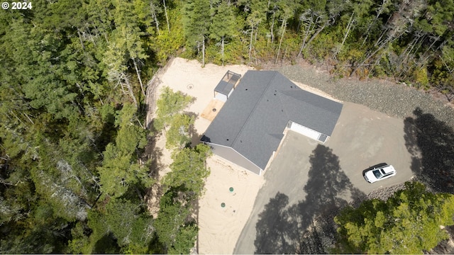 birds eye view of property with a forest view