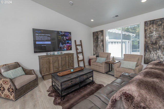 living area with lofted ceiling, light wood-type flooring, visible vents, and recessed lighting