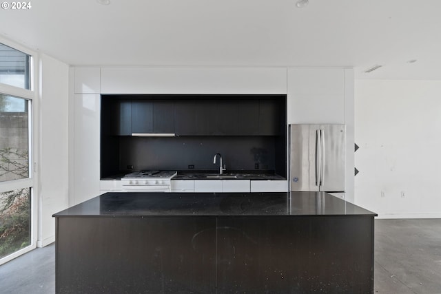 interior space featuring concrete floors, sink, and appliances with stainless steel finishes