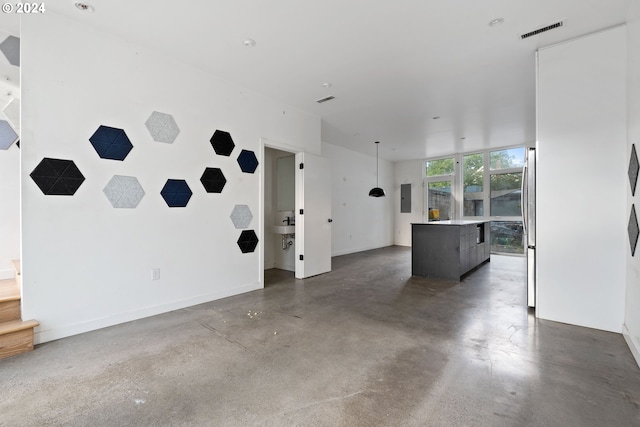 unfurnished living room featuring concrete flooring and electric panel