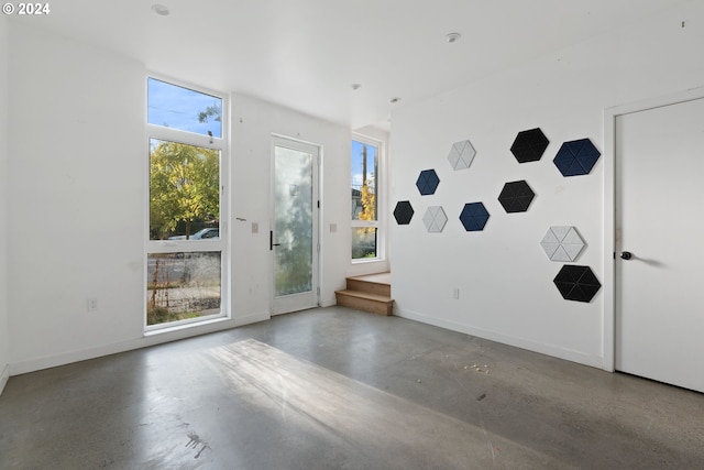 interior space featuring plenty of natural light and concrete floors