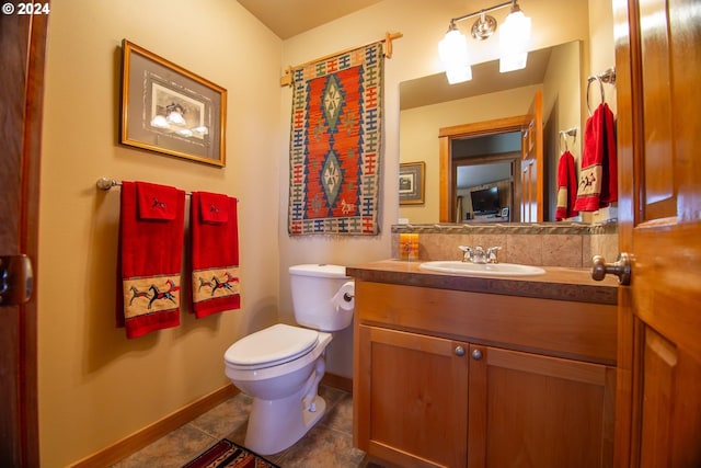 bathroom featuring tile patterned flooring, vanity, and toilet