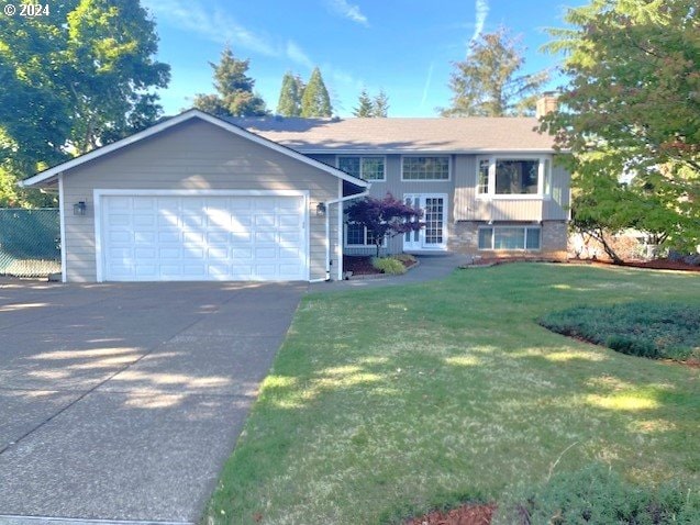 view of front of property with a garage and a front yard