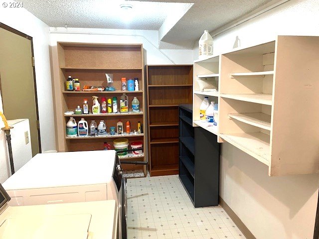 pantry with washer and clothes dryer