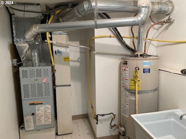 utilities with gas water heater and sink