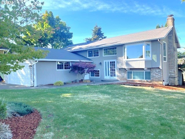 exterior space featuring a front lawn and a garage