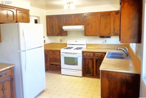 kitchen with sink and white appliances