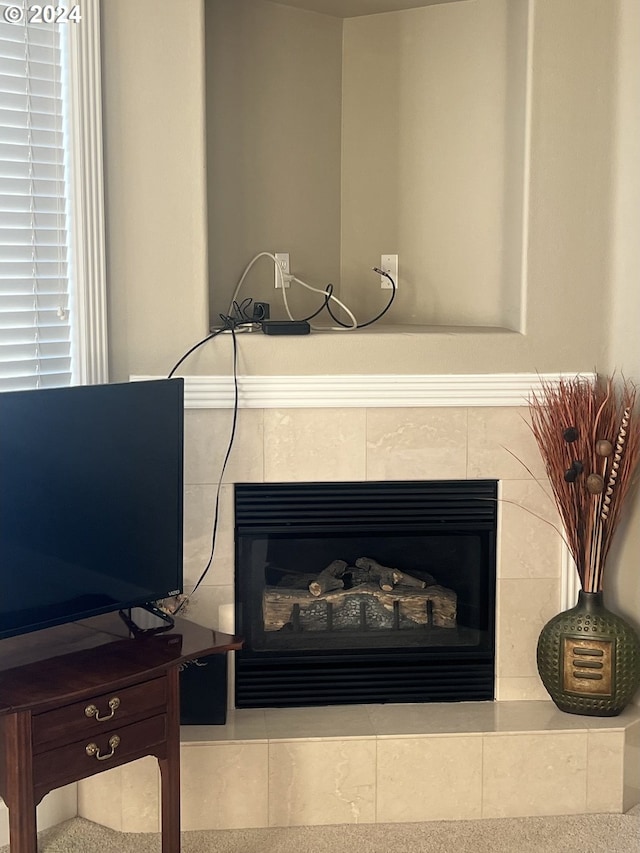 interior details with a tile fireplace