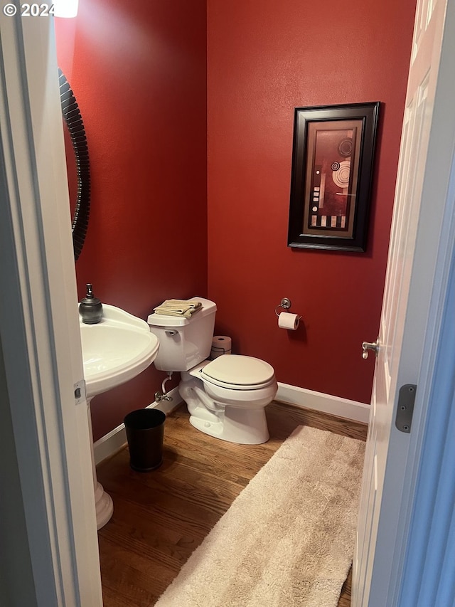 bathroom featuring hardwood / wood-style floors and toilet