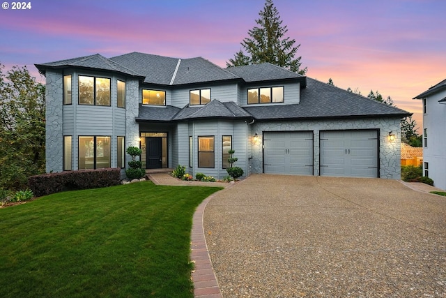 view of front of house featuring a yard and a garage