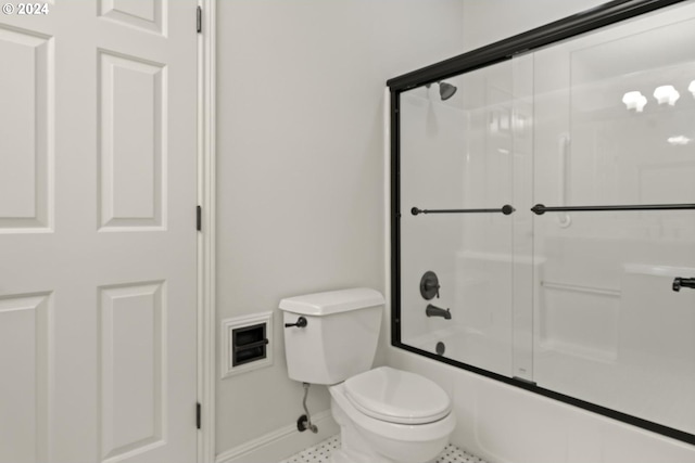 bathroom with shower / bath combination with glass door, toilet, and tile patterned flooring