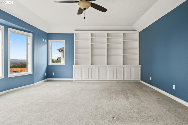 spare room with light colored carpet and ceiling fan