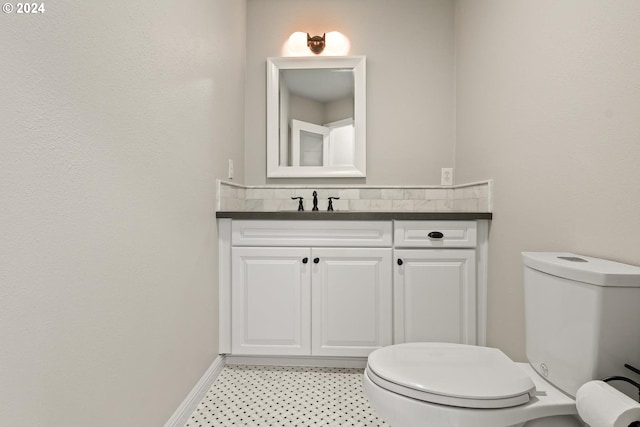 bathroom with toilet and vanity