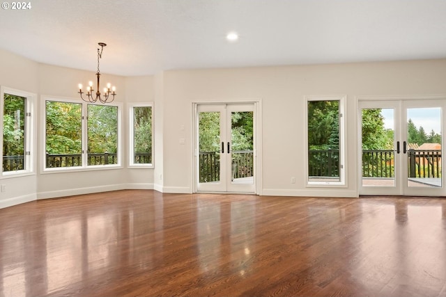 interior space with french doors, hardwood / wood-style flooring, and a chandelier