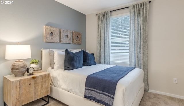 bedroom featuring carpet flooring and baseboards