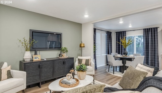 living area with recessed lighting and wood finished floors