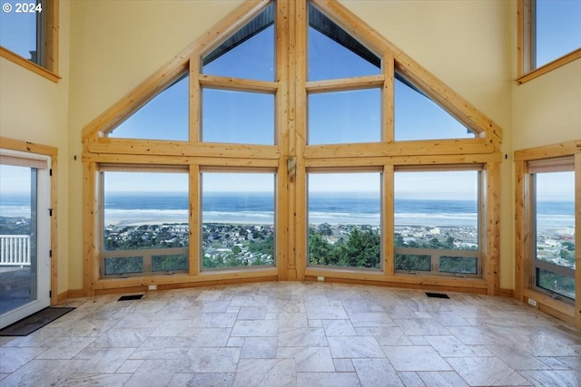 unfurnished sunroom featuring a water view