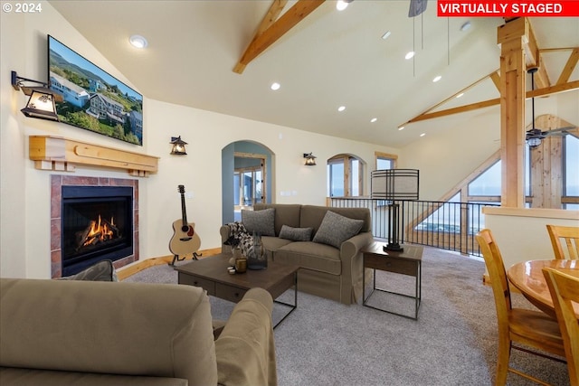 carpeted living room with a healthy amount of sunlight, beamed ceiling, a fireplace, and ceiling fan