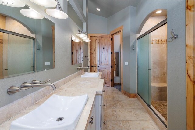 bathroom featuring vanity, vaulted ceiling, and an enclosed shower