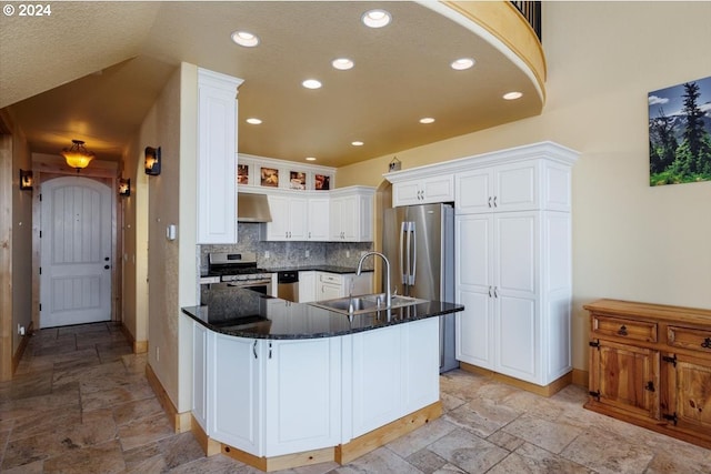 kitchen featuring white cabinetry, tasteful backsplash, kitchen peninsula, ventilation hood, and sink