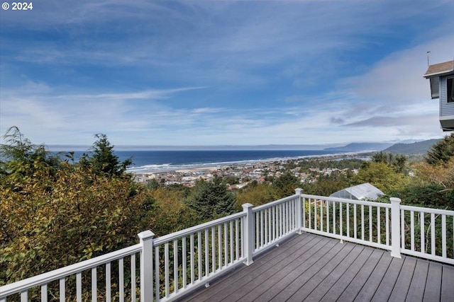 deck featuring a water view and a beach view