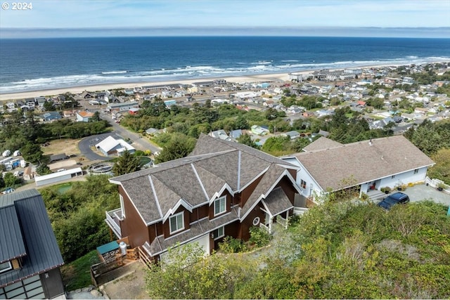 drone / aerial view featuring a view of the beach and a water view