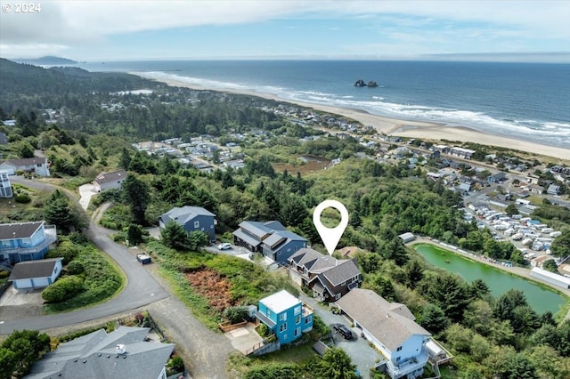 birds eye view of property featuring a view of the beach and a water view