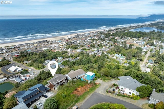 drone / aerial view with a water view and a view of the beach