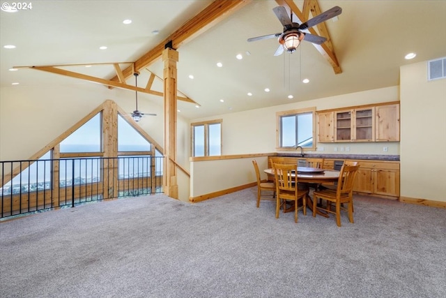 dining space featuring sink, beam ceiling, light colored carpet, high vaulted ceiling, and ceiling fan