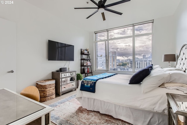 bedroom with multiple windows, ceiling fan, and light hardwood / wood-style floors