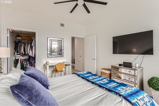 bedroom with ceiling fan, a walk in closet, and a closet