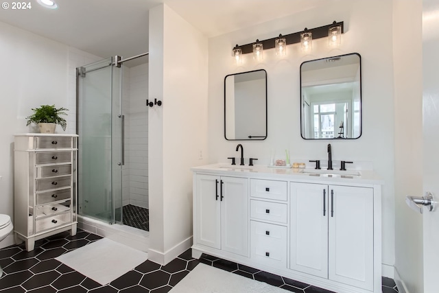 bathroom featuring tile patterned flooring, vanity, and walk in shower