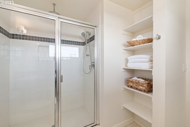 bathroom with a shower with door