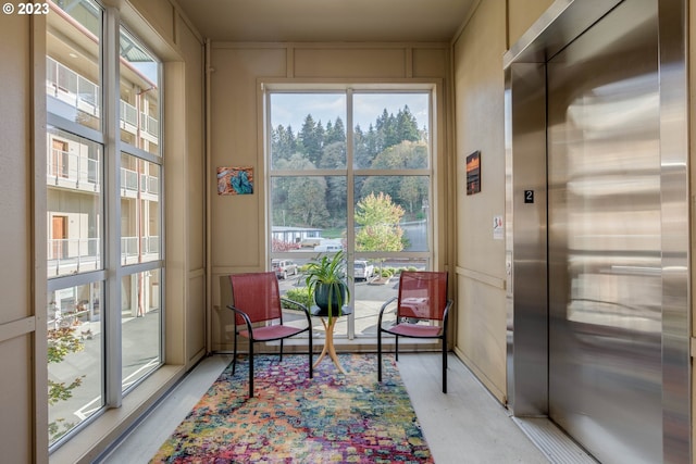 living area with elevator and plenty of natural light