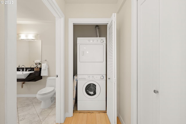 laundry area featuring stacked washing maching and dryer