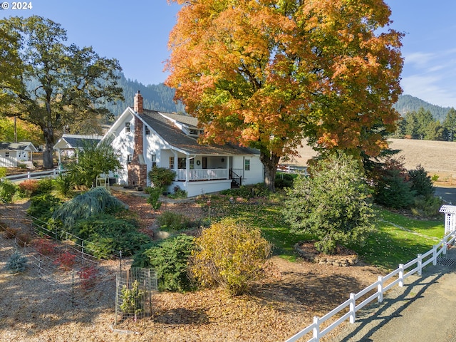 exterior space with a porch and a mountain view