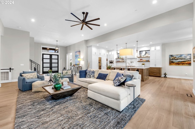 living room with light hardwood / wood-style floors and ceiling fan