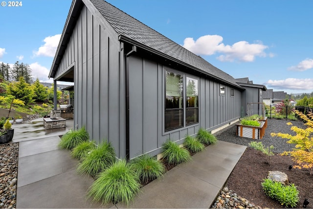 view of property exterior with a patio area