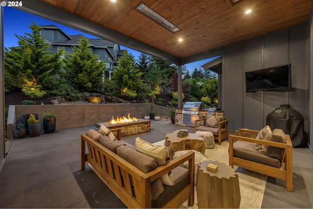 view of patio featuring an outdoor kitchen, grilling area, and an outdoor living space with a fire pit