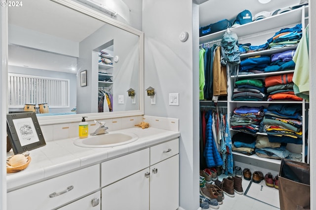 bathroom featuring tile patterned flooring and vanity