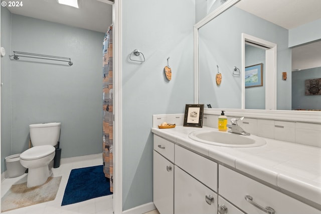 bathroom with vanity, tile patterned flooring, and toilet