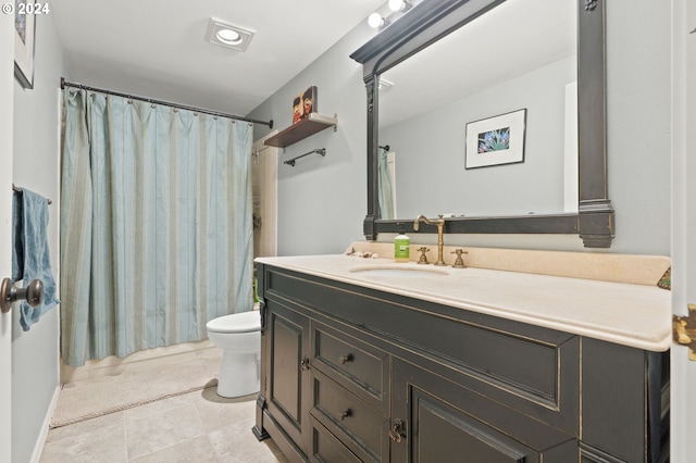 bathroom featuring toilet, vanity, and tile patterned floors