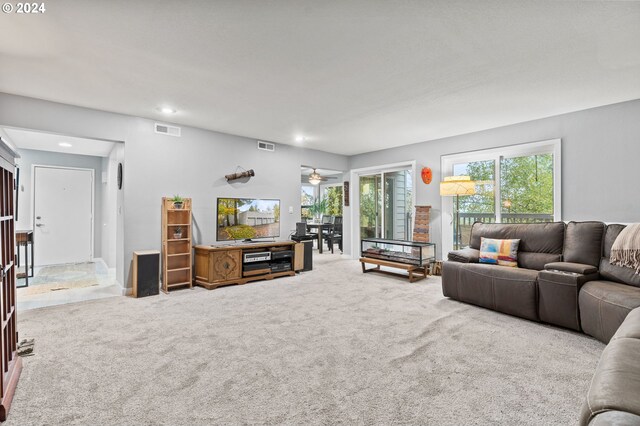 living room featuring carpet and ceiling fan