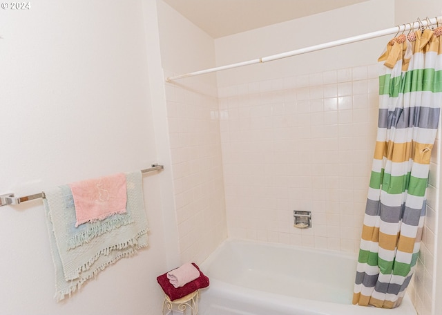 bathroom with shower / bathtub combination with curtain