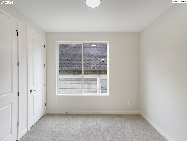 unfurnished bedroom with light colored carpet