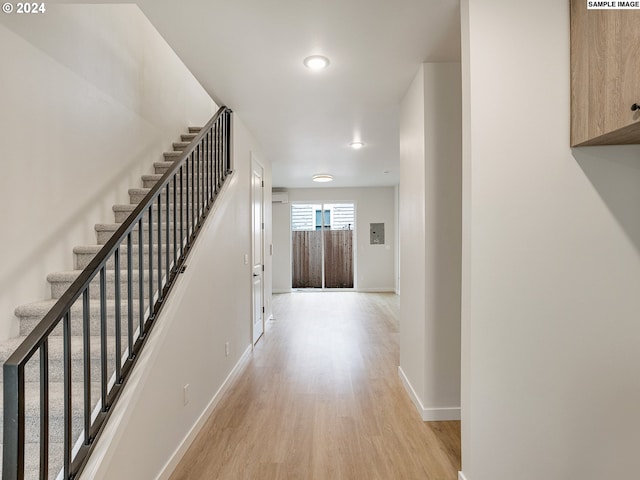 hallway with light hardwood / wood-style floors