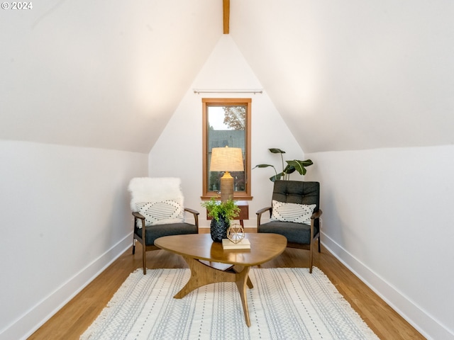 sitting room featuring wood-type flooring and lofted ceiling